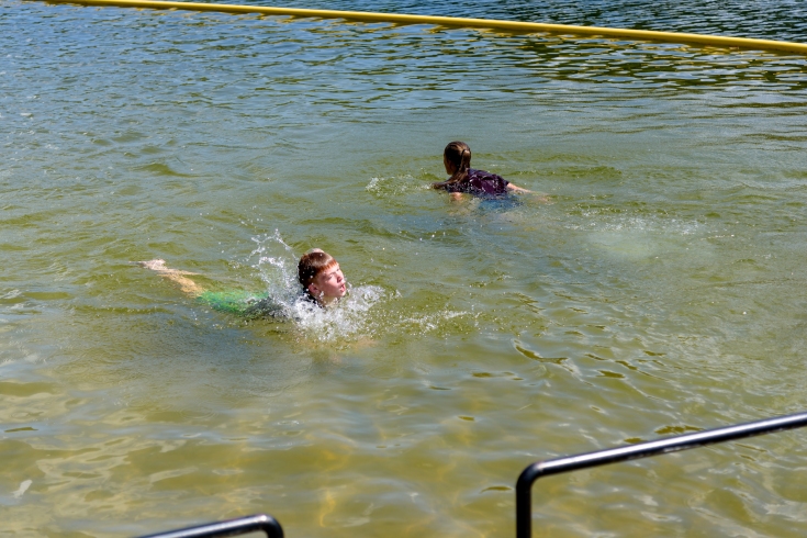 TFS cross country team members swim Terrora beach as part of their annual quadrathlon.